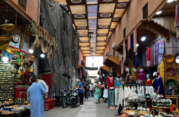 Narrow alleys of Marrakesh Medina with colorful shops and cafes