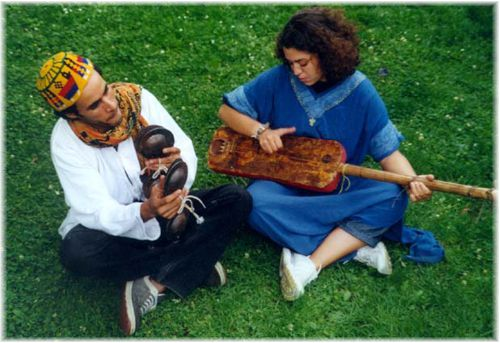 A Gnawa musician playing the guembri, a traditional stringed instrument, during a Moussem festival