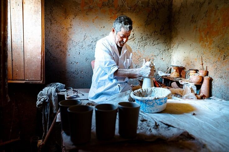 A Safi potter hand-throwing a ceramic vessel on a traditional wheel