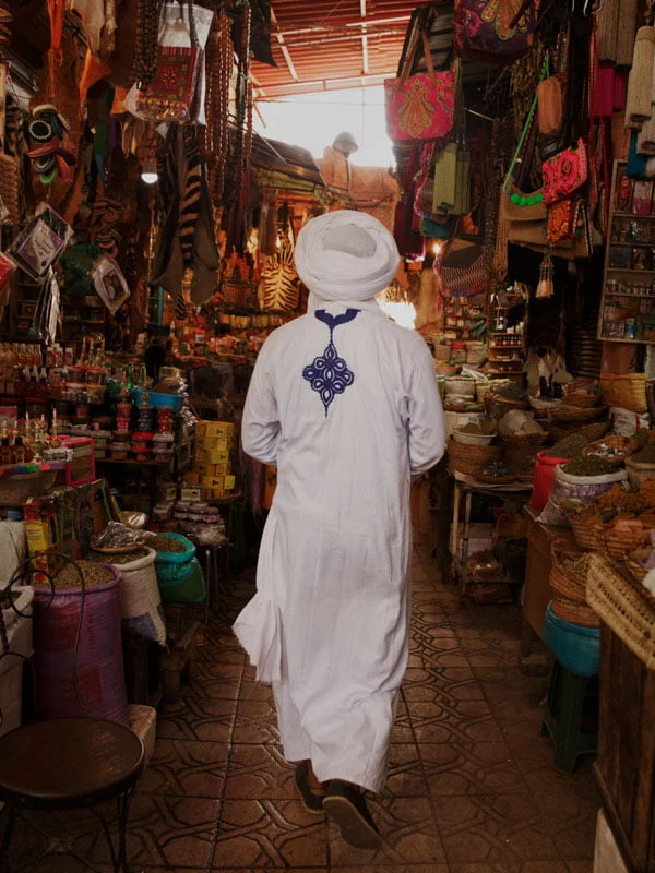 A bustling Moroccan market stall overflowing with aromatic incense sticks and fragrant spices