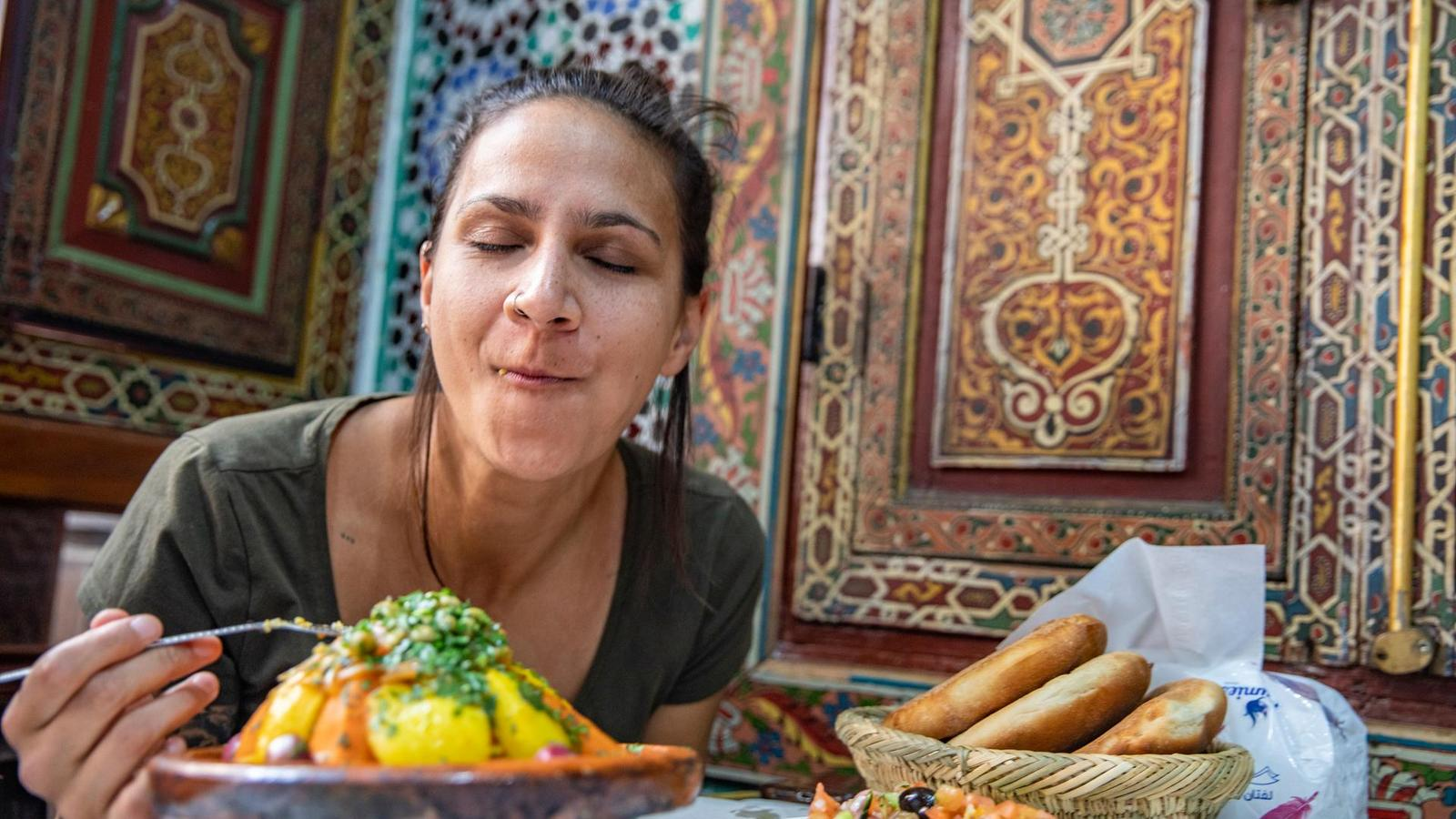 A bustling street in Marrakech's old medina, with vibrant colors and Moorish-inspired architecture