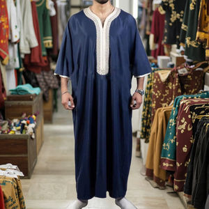 A man wearing a traditional caftan with a turban