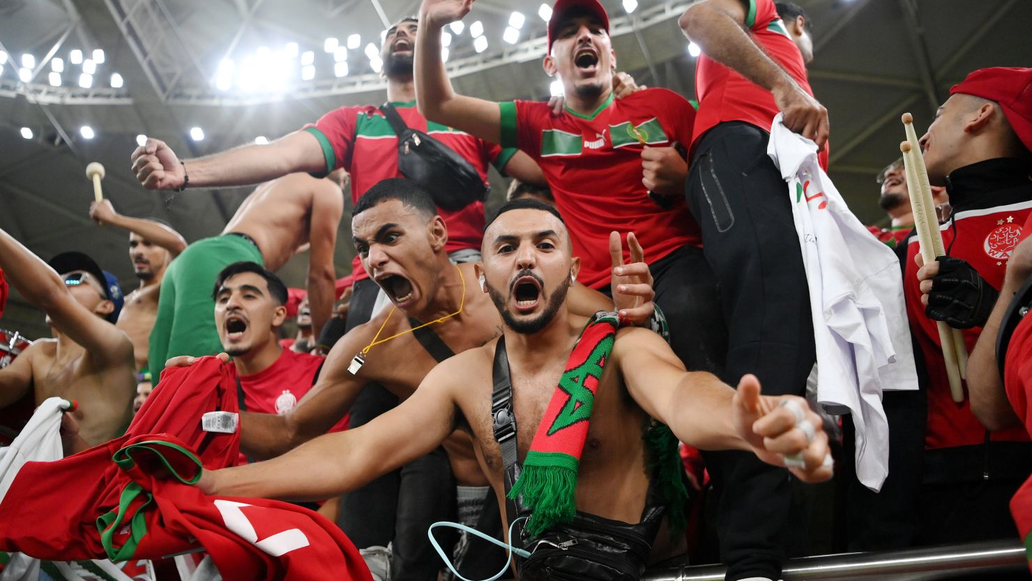 Moroccan fans celebrating a victory with flags and traditional clothing