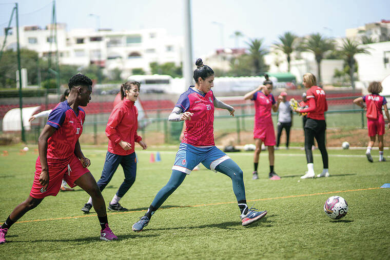 Young Moroccan footballers in training, wearing traditional clothing