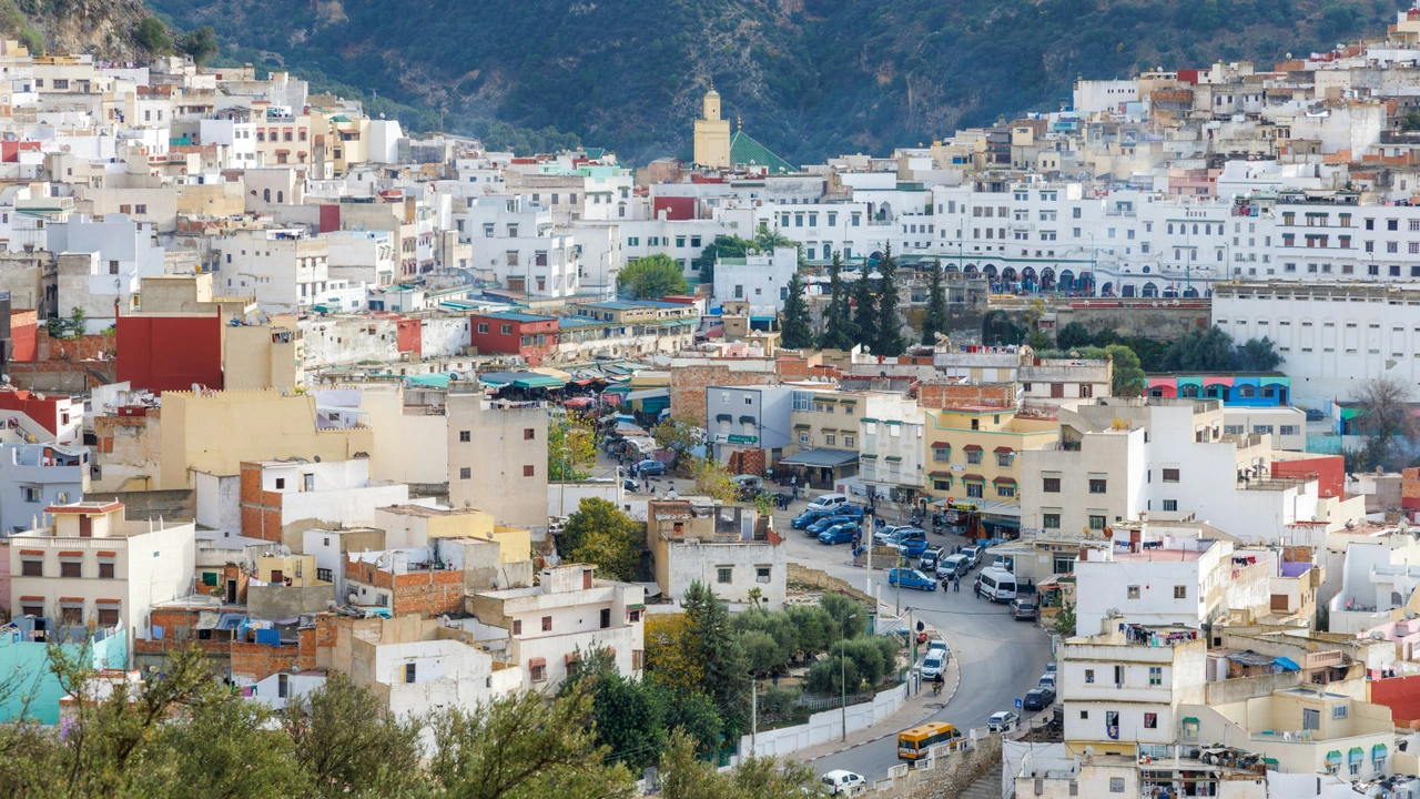 The majestic mosque of Moulay Idriss Zerhoun, with its white minaret and intricate tile work, nestled in the Middle Atlas Mountains