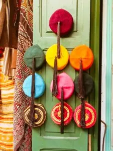 A modern Moroccan artisan crafting a Tarbouche in a traditional workshop