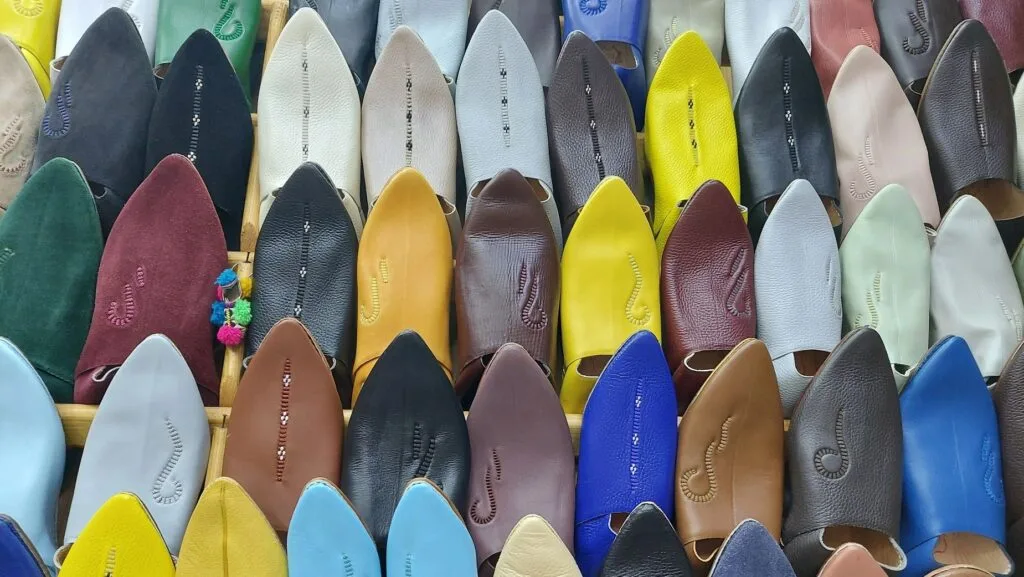 Colorful Babouche slippers on display in a Moroccan souk