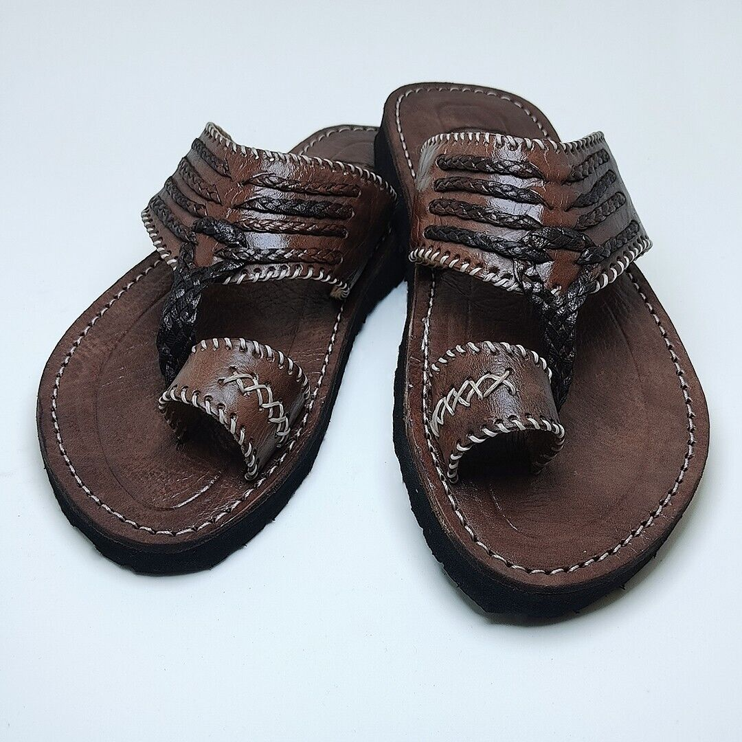 Moroccan artisan carefully stitching a babouche slipper