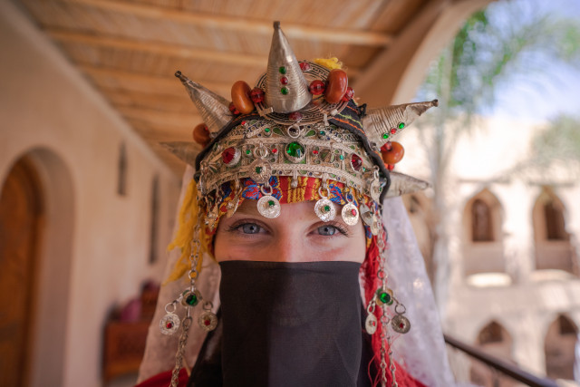 Moroccan bride with intricate henna designs on her hands and feet