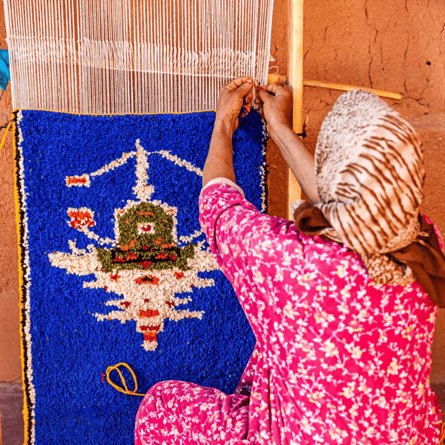 Berber artisan weaving a carpet in the Atlas Mountains
