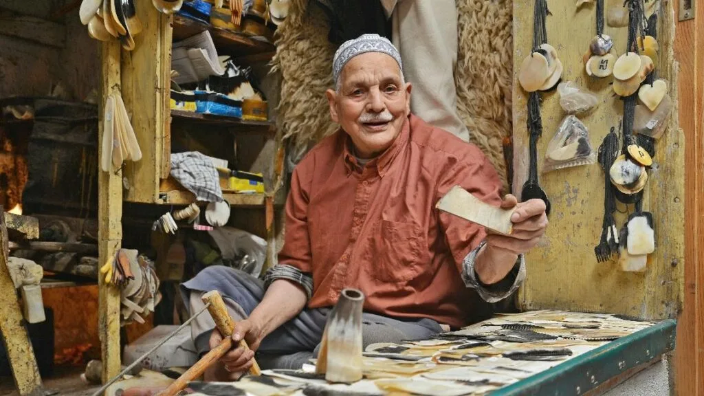 Artisans in Fes Medina sharing their skills and knowledge with apprentices, ensuring the continuation of the traditional craft