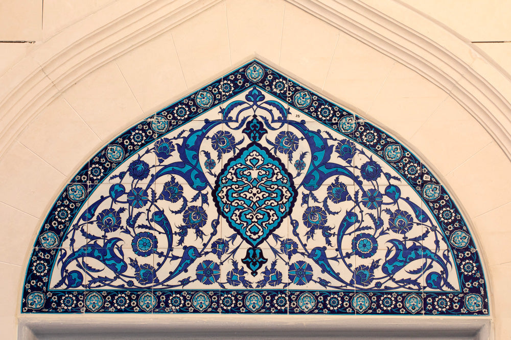 Intricate Zellij tile designs featuring geometric shapes, floral motifs, and Arabic calligraphy