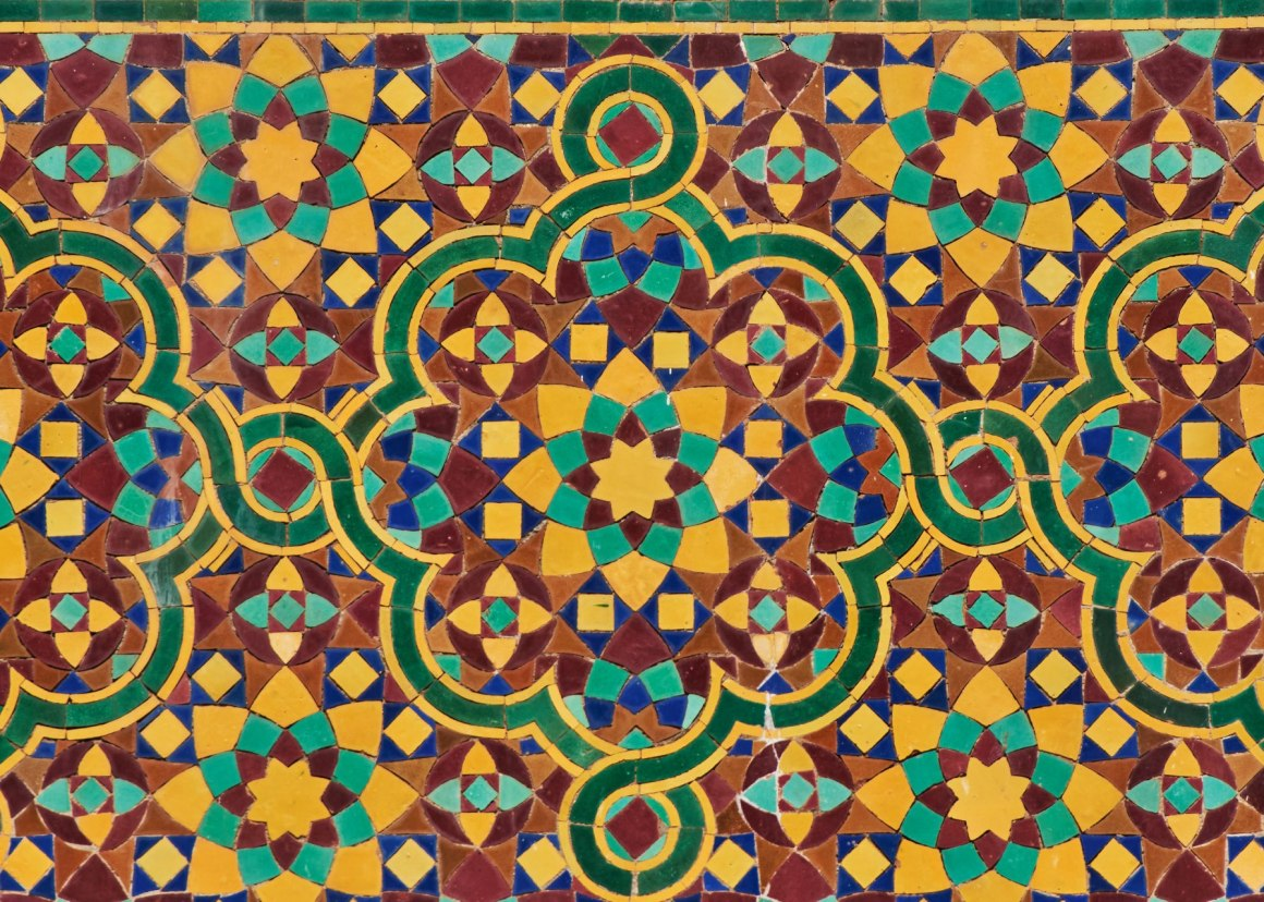 A skilled artisan carefully crafts Zellij tiles, passing on the traditional techniques to the next generation