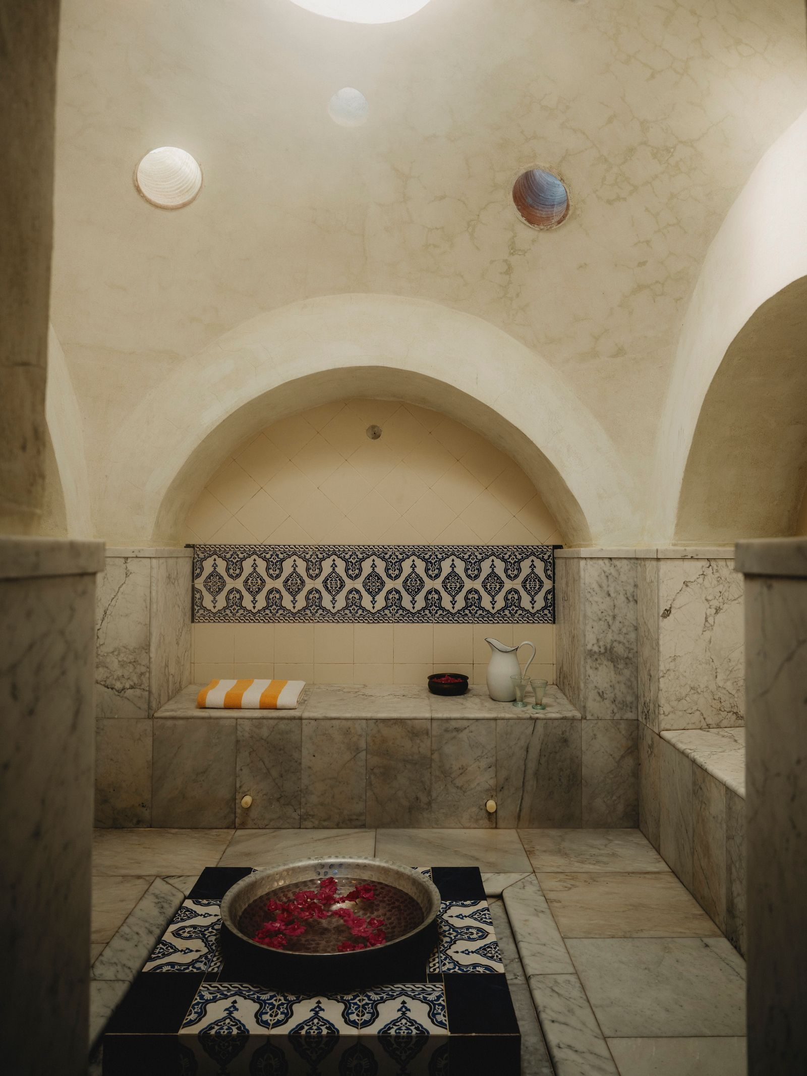 A beautifully restored historic hammam in Marrakech, with intricate tiles and ornate architecture