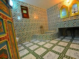 A traditional Hammam exterior, adorned with intricate zellij tiles, in the old medina of Fez