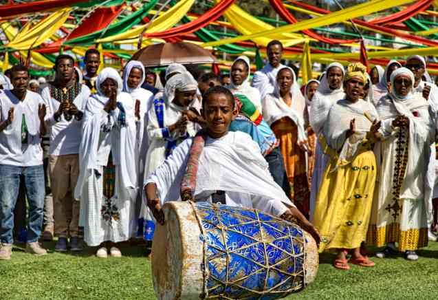 A vibrant scene from the Fez Festival of World Sacred Music, featuring a whirling dervish performance